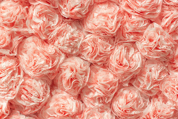 Decorative paper roses from napkins as texture background pattern. Creative festive wall decoration - Foto, afbeelding