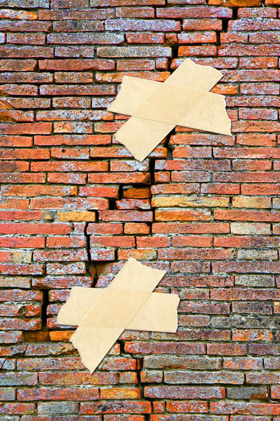 Renovation of cracked brick wall - concept image with adhesive t - Photo, Image