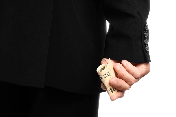 Business man holding money on white background - 写真・画像