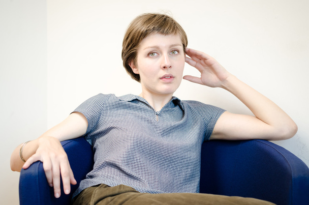 young beautiful hipster woman sitting in the armchair - Фото, зображення