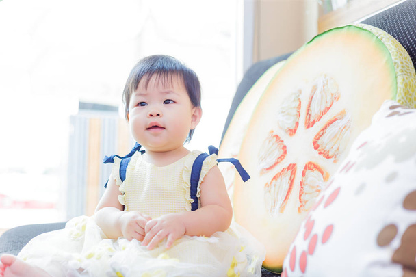 Cute baby girl smile and hold flower. - 写真・画像