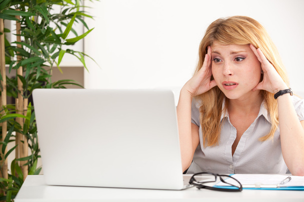 Woman looking surprised with laptop - Photo, Image