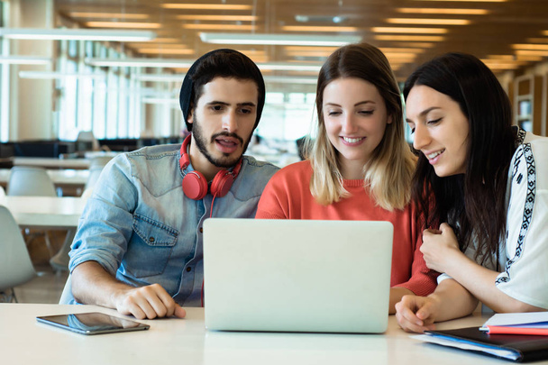 University students using laptop in university library.  - Foto, imagen