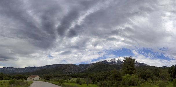 Vista panoramica della montagna innevata Dirfys e cielo con nuvole sull'isola di Evia, Grecia - Foto, immagini