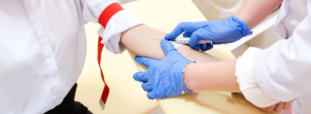 Preparation for blood test. Medical technician preparing before taking a blood sample from patient. - Photo, Image