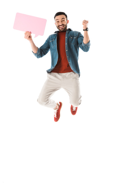 cheerful bearded man with speech bubble jumping and showing yes gesture isolated on white - Photo, Image