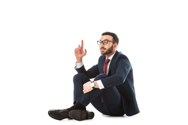 usmívající se podnikatel s nápadem při sezení na bílém pozadí - Fotografie, Obrázek