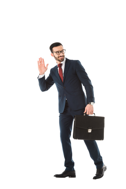 smiling businessman with briefcase looking back and showing hello gesture isolated on white - Φωτογραφία, εικόνα