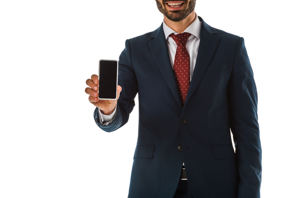 partial view of businessman in black suit holding smartphone with blank screen isolated on white - Foto, imagen