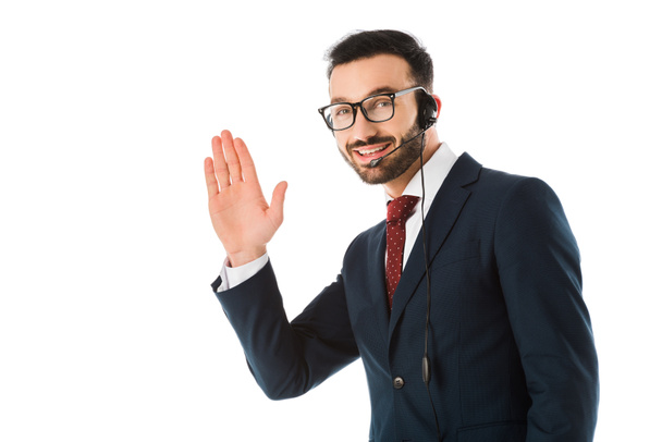 handsome call center operator in headset smiling and showing idea gesture isolated on white - Fotó, kép