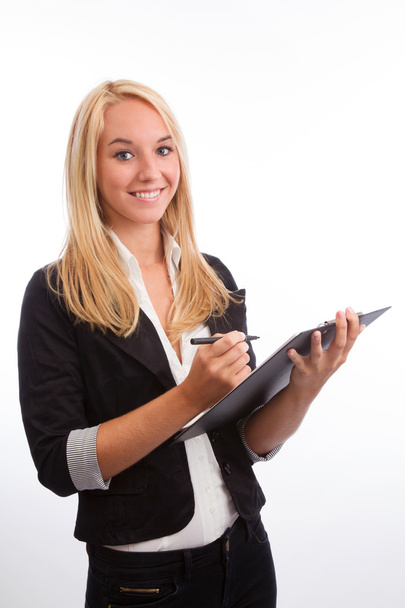Young woman with checklist looking into camera - Foto, imagen