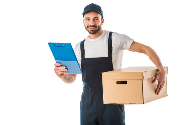 handsome delivery man with cardboard box holding clipboard and looking at camera isolated on white - Photo, Image