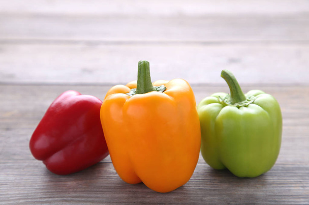 Colorful pepper on a grey wooden background - Zdjęcie, obraz