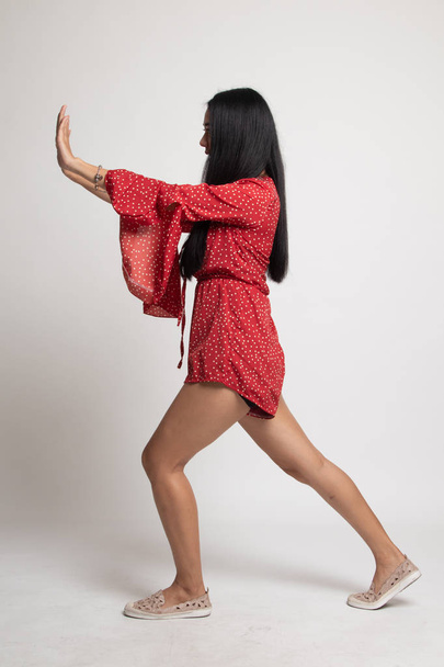 Full body of beautiful young asian woman push something. - Фото, изображение