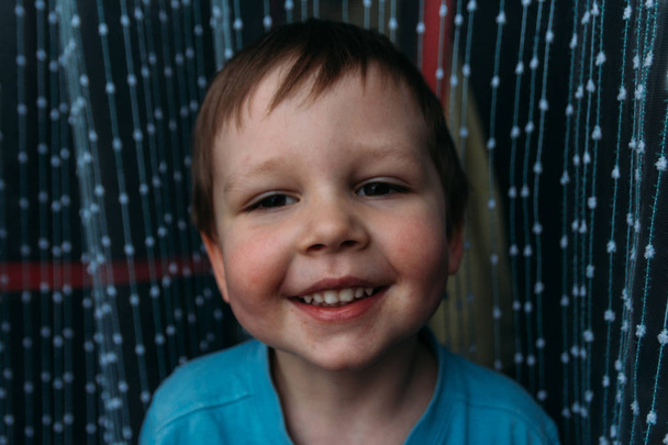 naughty boy smiling at camera, portrait of a child - Fotó, kép