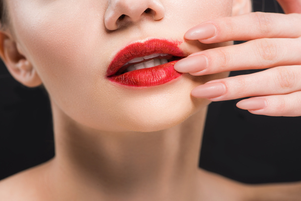 cropped view of girl touching red lips isolated on black  - Foto, Imagem