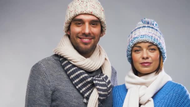 happy couple in winter clothes waving hands - Video, Çekim