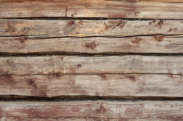 Beautiful wooden background from old weathered horizontal logs with knots and moss. view of the wal - Foto, Imagem