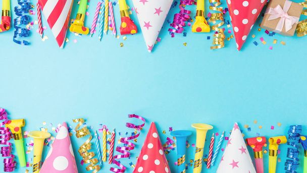 Colorful celebration background with various party confetti, streamers and decoration. Minimal party concept. Flat lay. - Foto, Bild