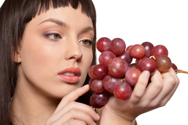 Portrait of young woman posing  with grapes  isolated on white background - Fotografie, Obrázek