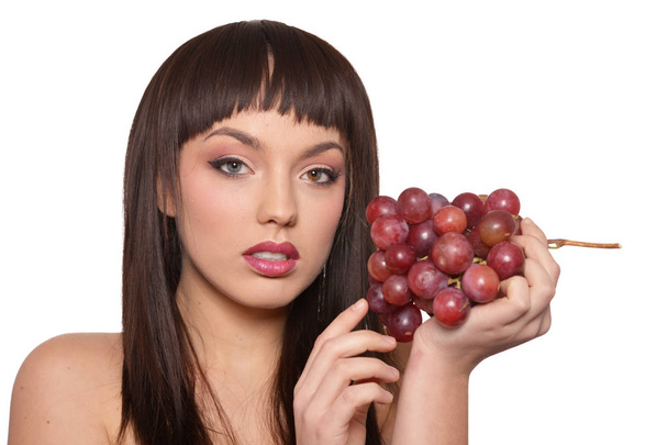 Portrait of young woman posing  with grapes  isolated on white background - Foto, imagen