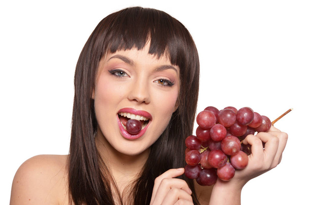 Portrait of young woman posing  with grapes  isolated on white background - Fotografie, Obrázek