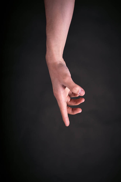 Man hand pointing on a dark background - Foto, Imagem