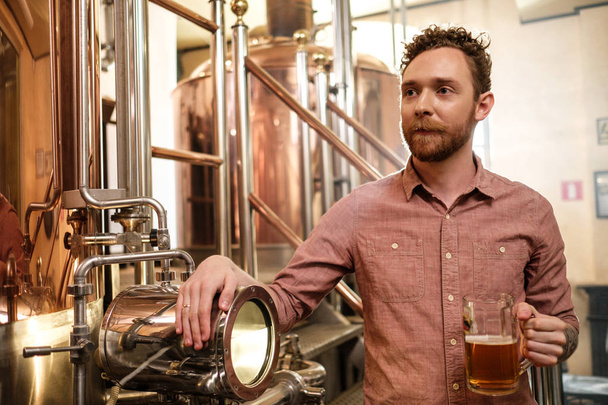 醸造所で新鮮なビールを味わう男 - 写真・画像