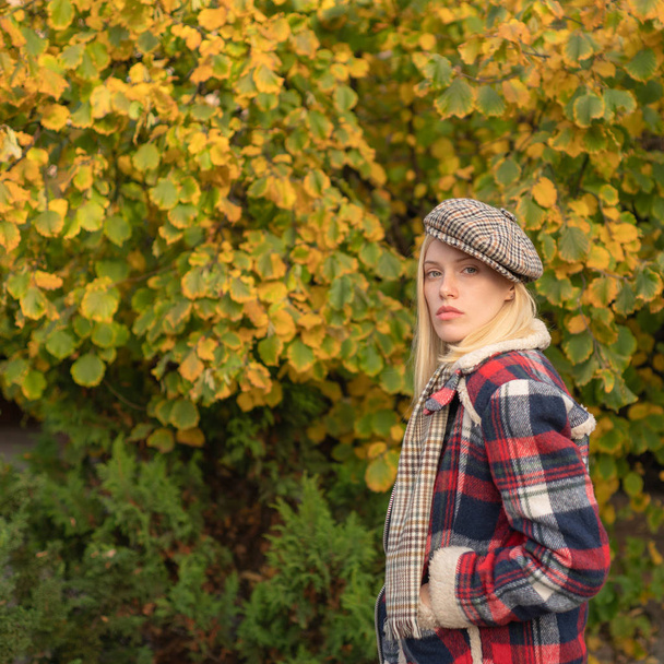 Pretty woman in hat. Woman wear checkered clothes nature background. Girl wear kepi. Fall fashion accessory. Adorable fashion girl. Enjoy fall season. Autumn is here. Fashion trend. Manly world - Photo, image