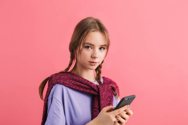 Porträt eines jungen schönen Mädchens mit zwei Zöpfen in lila T-Shirt - Foto, Bild