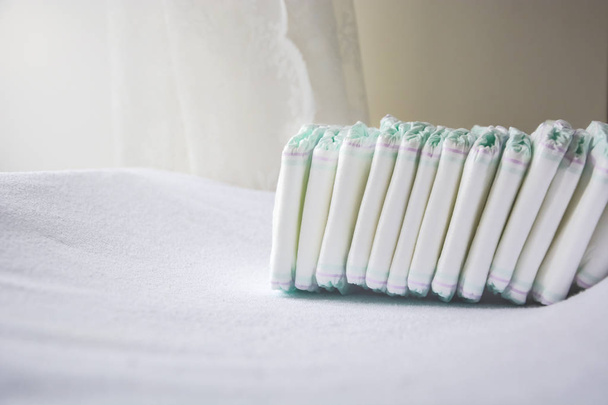 Group of disposable diapers arranged over a white changing table - Photo, Image