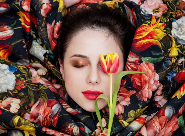 Portrait of a young girl with red lipstick and shrouded flower f - Фото, изображение
