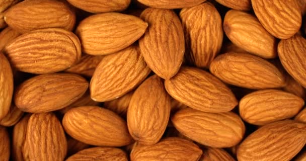 Almond nuts rotating in slow motion. Extreme close up top view, shot on RED 6K camera - Footage, Video