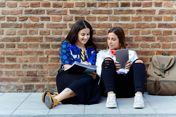 Two young friends using digital tablet. - Fotoğraf, Görsel
