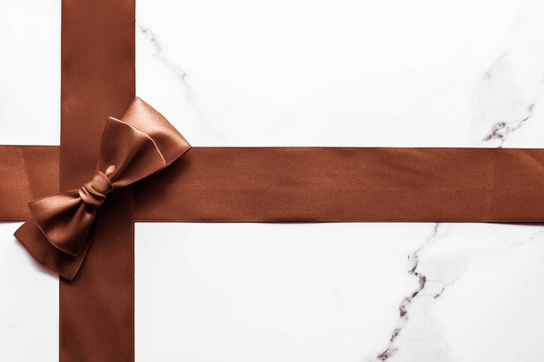 Chocolate brown silk ribbon on marble background, flatlay - Photo, Image