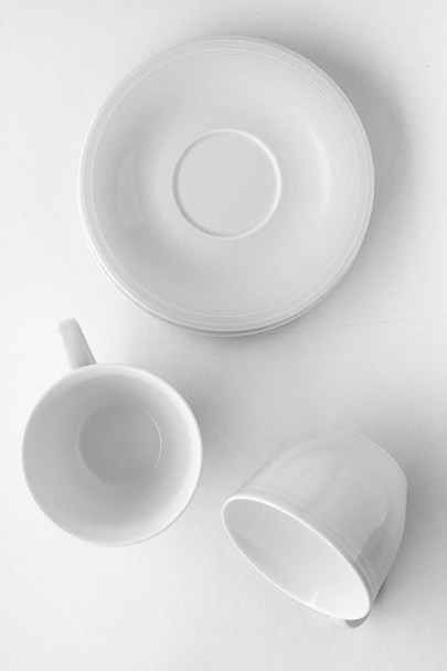 Empty cup and saucer mockup on white background, flatlay - Фото, изображение