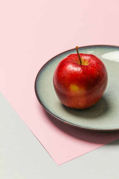 Свежесобранное красное яблоко в тарелке
 - Фото, изображение