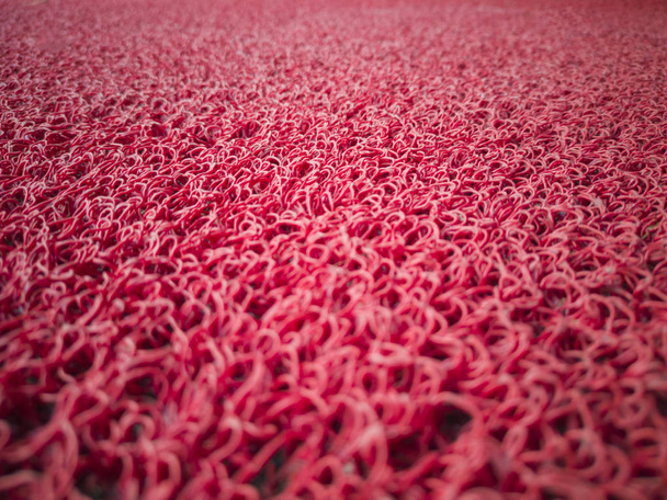 roter Hintergrund. Detail eines roten Teppichs. - Foto, Bild