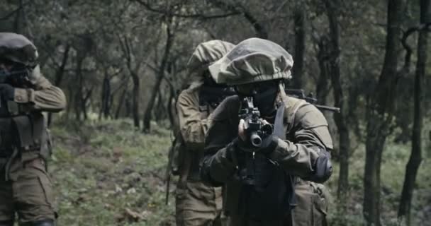 Squad of fully armed commando soldiers during combat in a forest scenery - Footage, Video