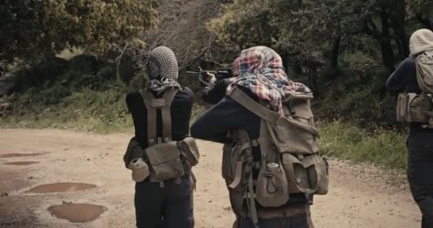 Escuadrón de terroristas armados patrullando una zona forestal durante el combate
 - Metraje, vídeo