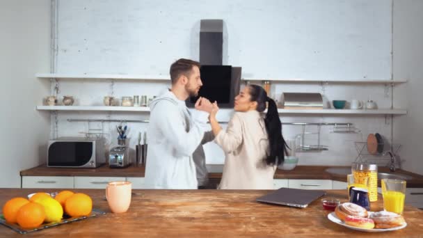 Beautiful caucasian couple wear tracksuits at their home on the weekend morning - Video, Çekim