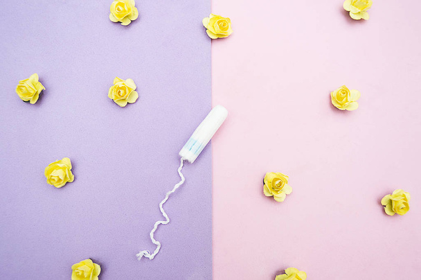 female tampon  with yellow flowers on pink violet background - Fotoğraf, Görsel