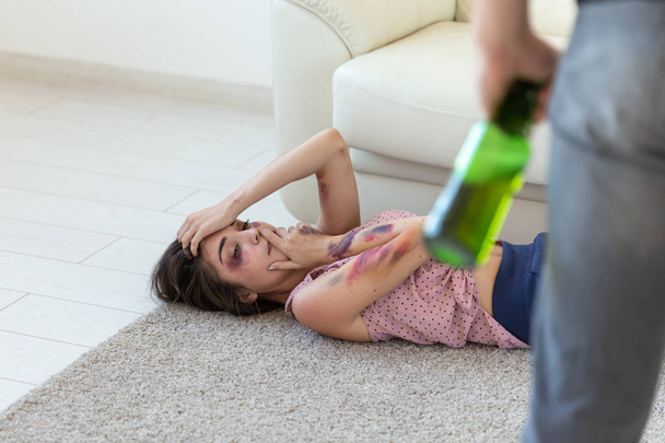 Victim, domestic violence, abuse and alcoholic concept - young couple in problems with drunk alcoholic husband - Photo, Image
