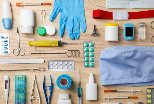 Flat lay composition with medical objects on wooden background - 写真・画像