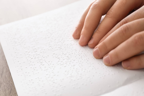 Blind man reading book written in Braille, closeup - Foto, Bild