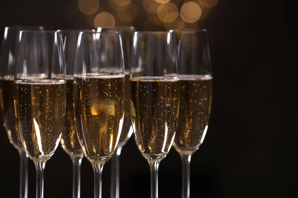 Glasses of champagne on blurred background, closeup. Space for text - Photo, Image