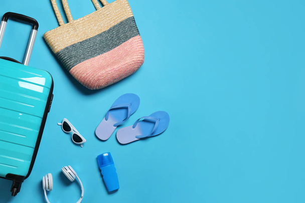 Flat lay composition with suitcase and accessories on color background, space for text. Summer vacation - Φωτογραφία, εικόνα