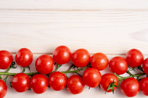 Cherry tomatoes on the white wooden table - Foto, imagen