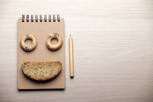 cookies notepad pencil wooden table nobody  - Valokuva, kuva