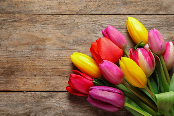 Beautiful tulips and space for text on wooden background, top view. Spring flowers - Fotó, kép